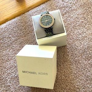 Used Michael Kors watch perfect condition roles gold black and gray band.